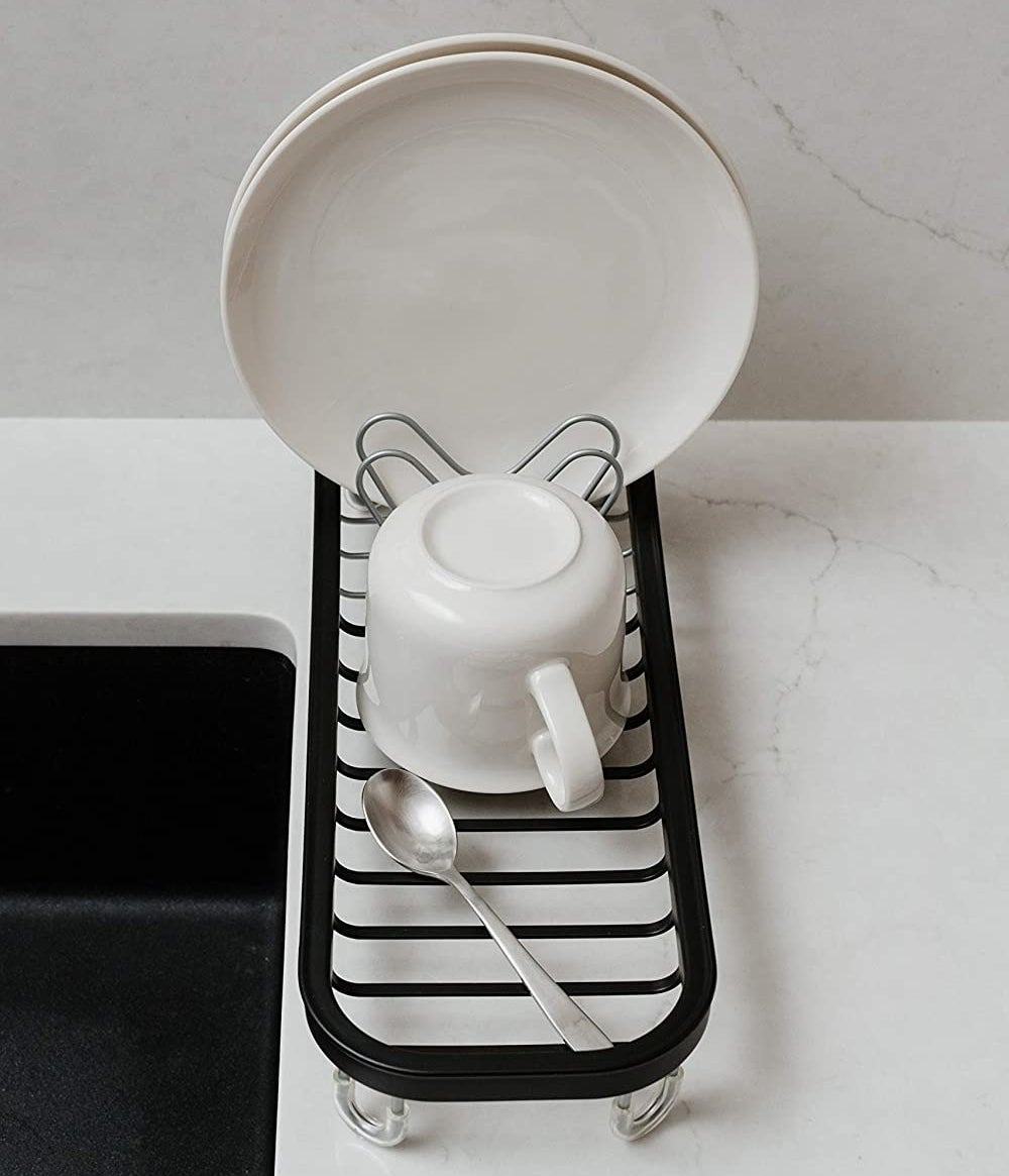 The dish-drying station with two plates, a mug, and a spoon on it