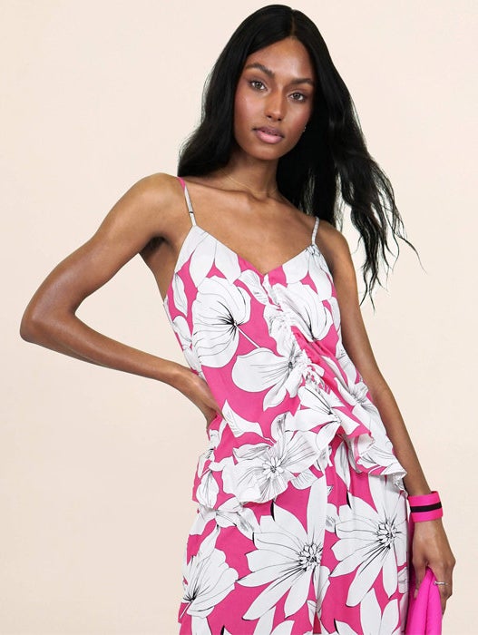 a model in the pink top and bottom with white flowers on it 