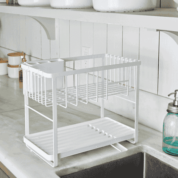 Double decker white dish rack filled with dishes 
