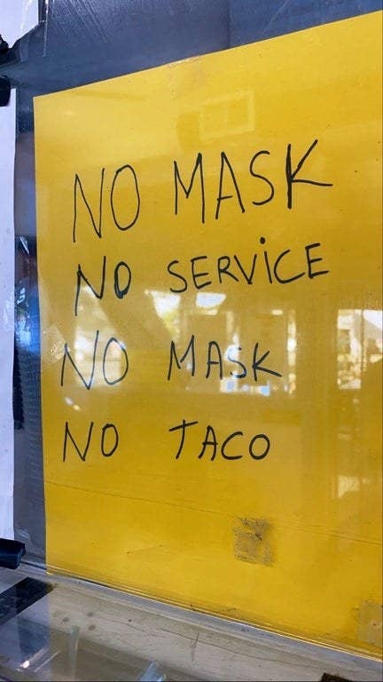 Sign reading no mask no service no mask no taco