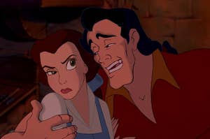 Gaston with his arm around Belle who is looking annoyed 