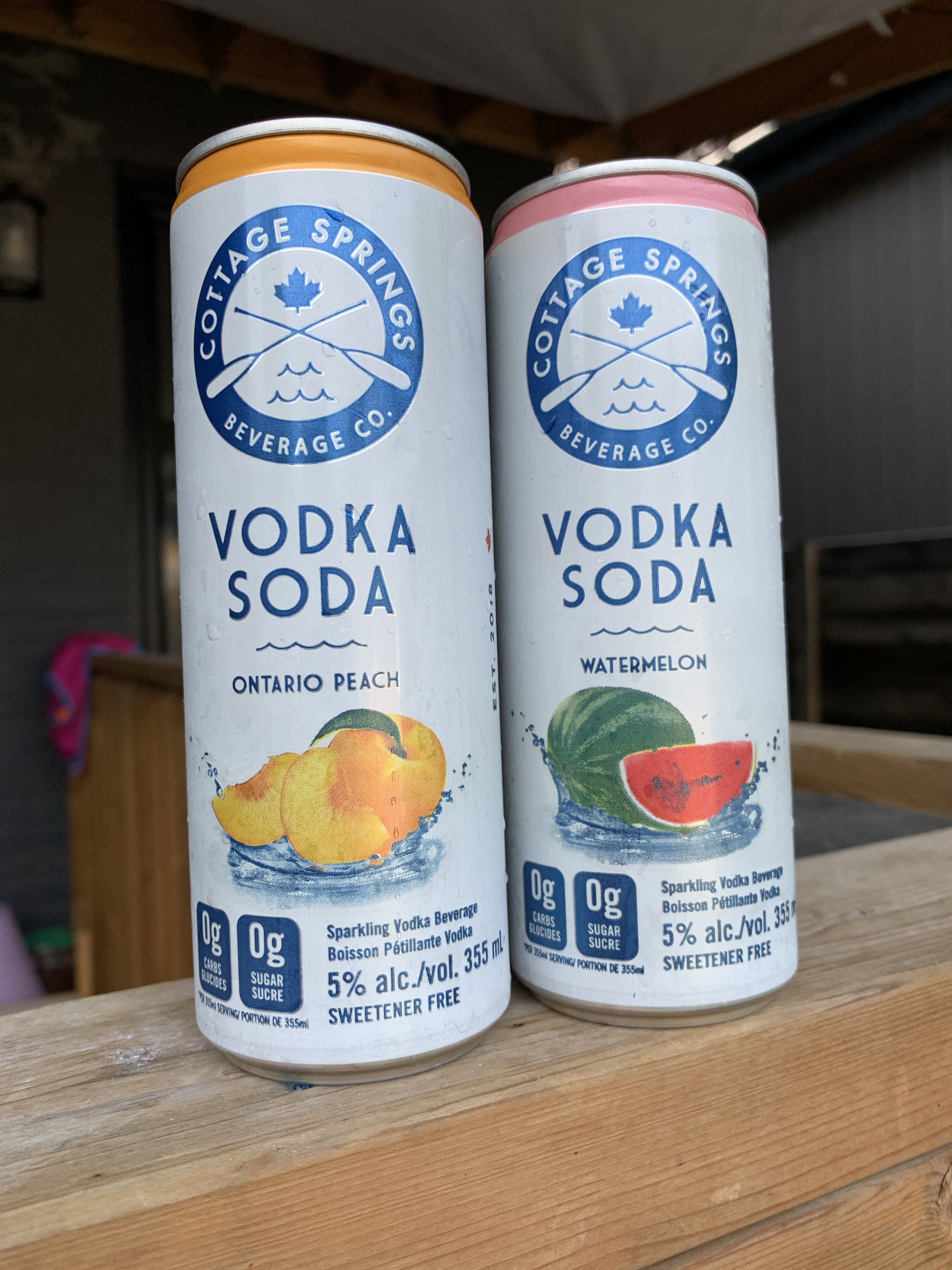 Two cans of vodka soda from Cottage Springs. One is Ontario Peach and one is Watermelon.