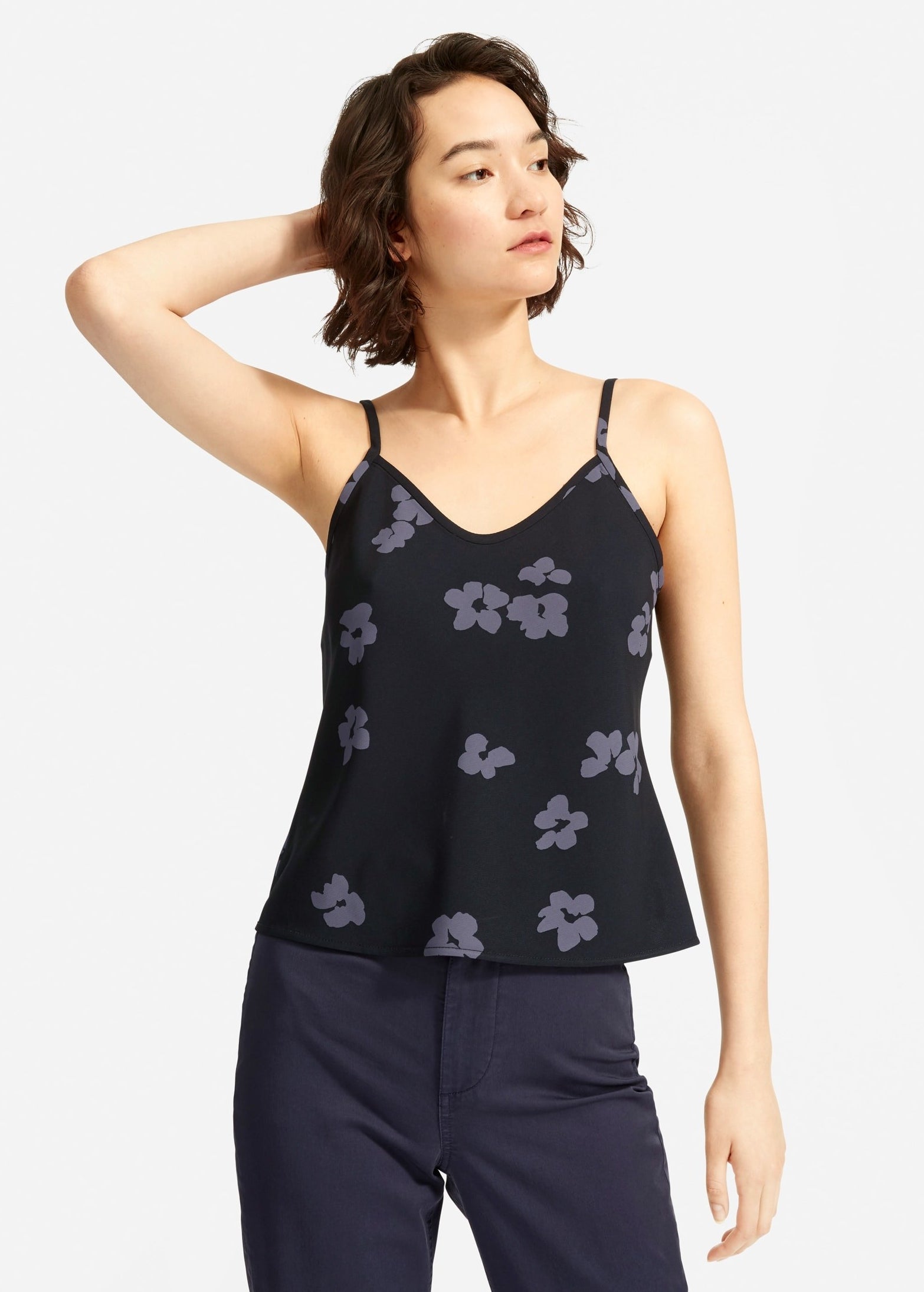 model in black cami with grey artistic flower print