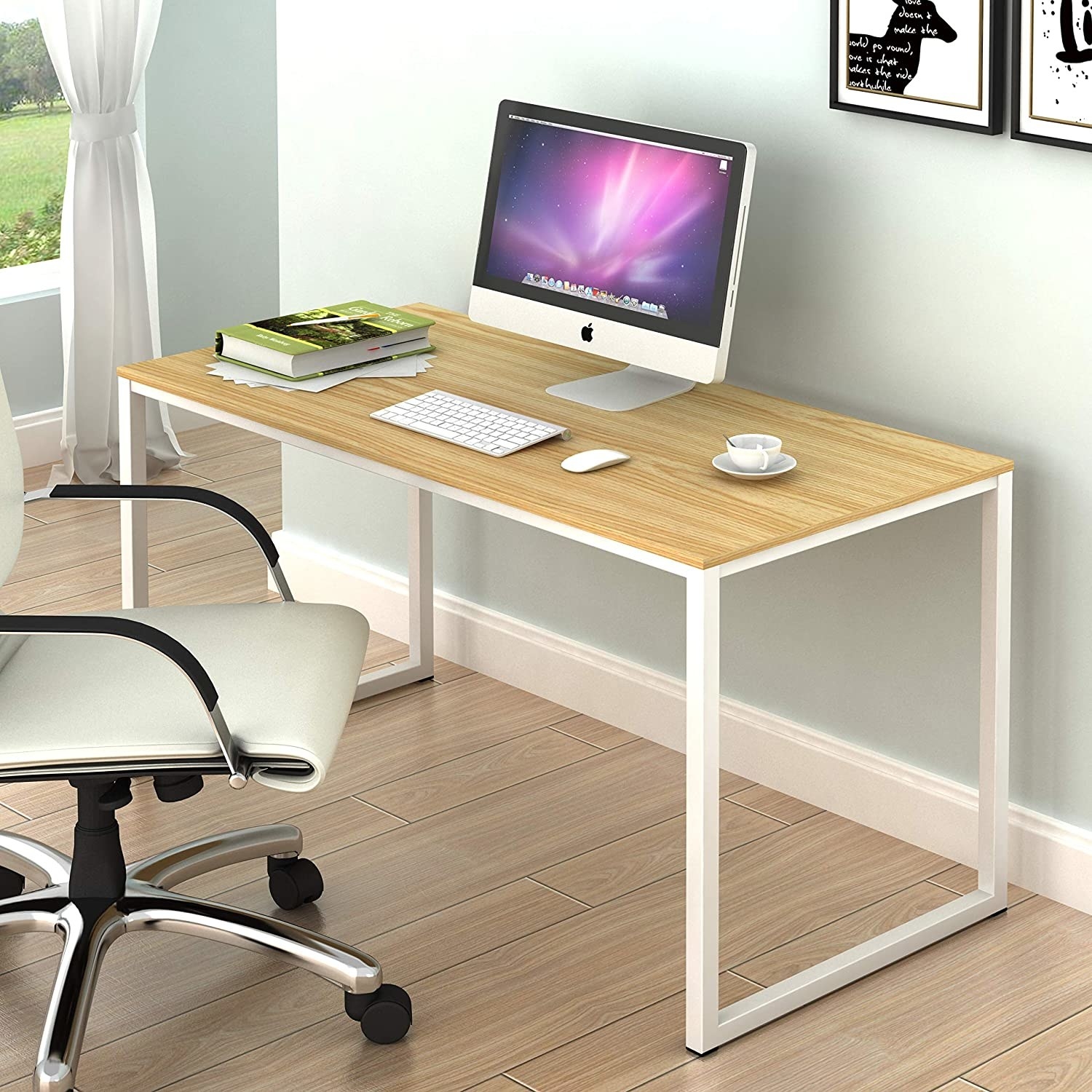 A desk in an office with a chair and a monitor