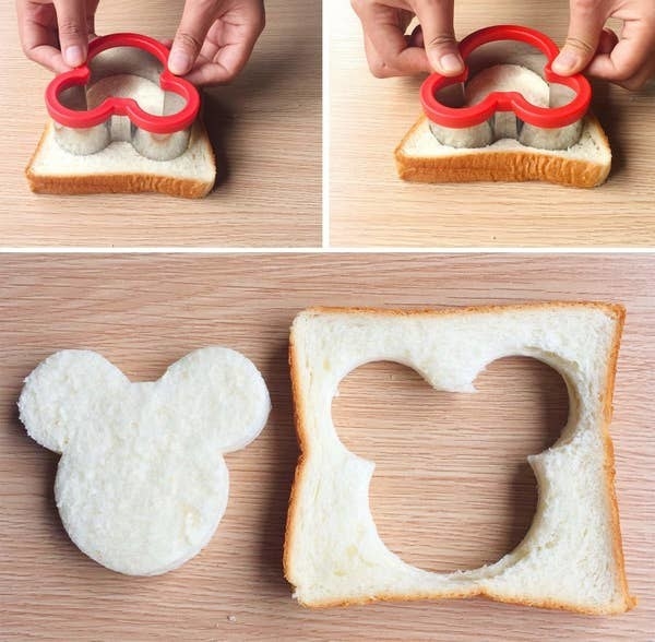 A person using the sandwich cutter
