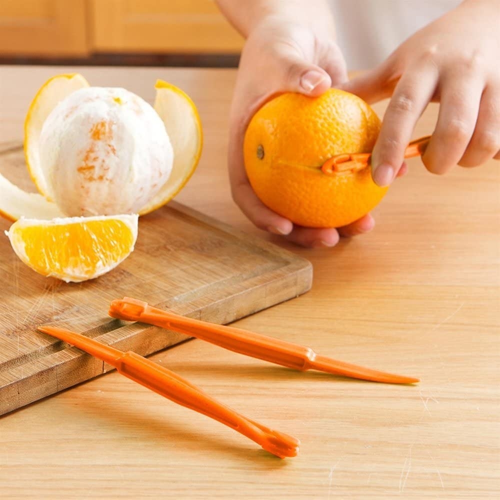 A model using the small tool to cut an orange 