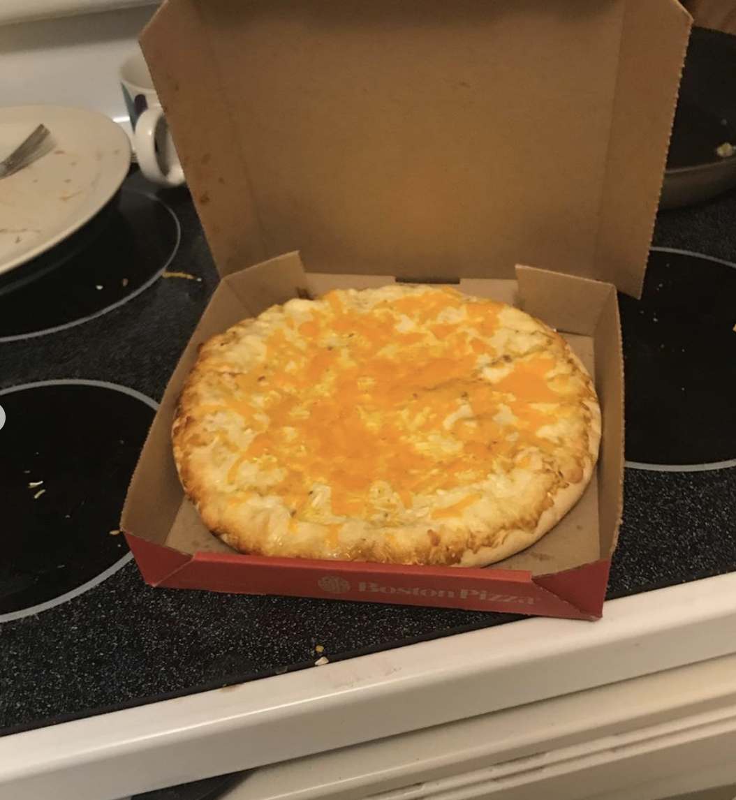 Very cheesy-looking pizza pie in a box