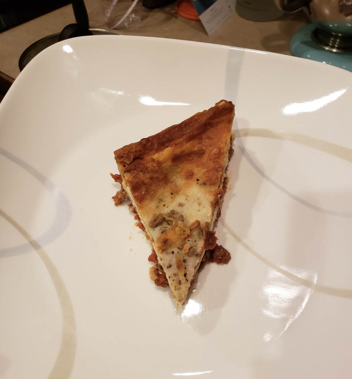 Triangle-shaped piece of lasagna on a plate