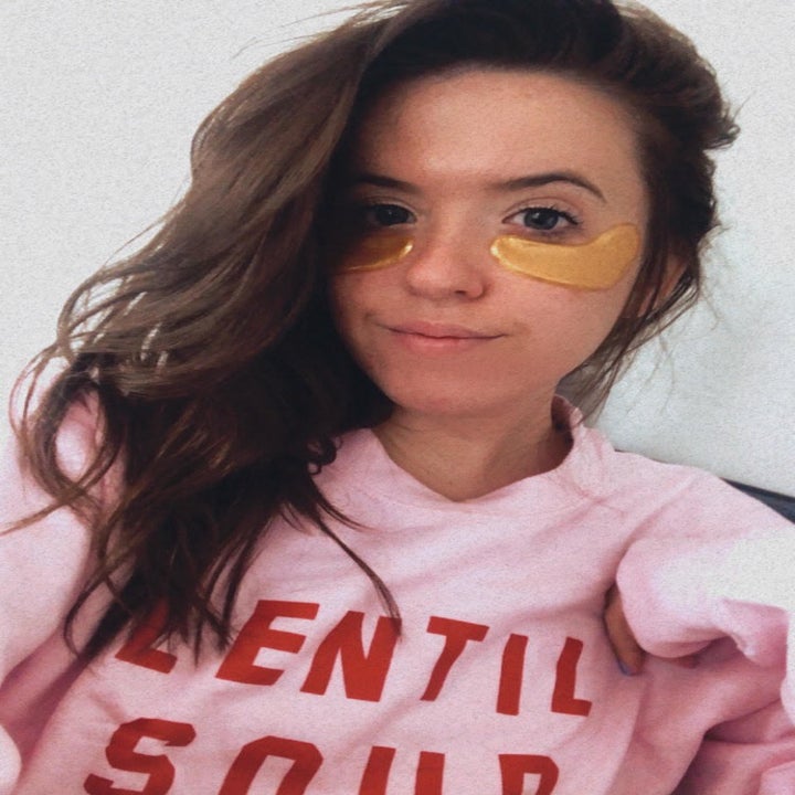 A person wearing the gold under-eye patches