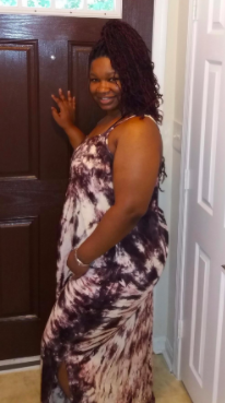 another reviewer pic wearing the dress, you can see how the dress has a slide slit to the knee and the tie-dye pattern joins at the side