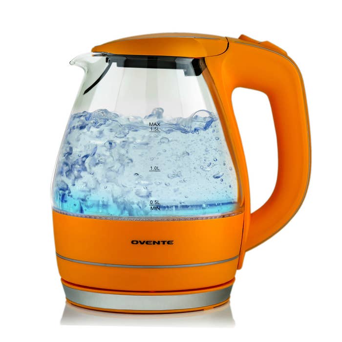 A glass kettle with orange plastic detailing 