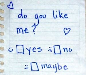 A piece of school paper with &quot;you like me: yes, no, maybe&quot; written on it and surrounded by hearts.