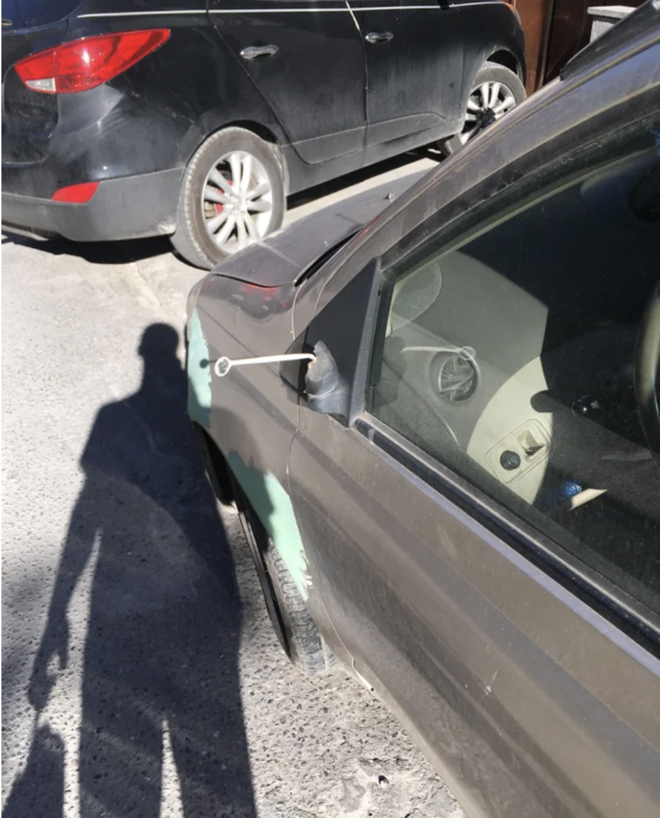 A tiny mirror has replaced a car&#x27;s side view mirror