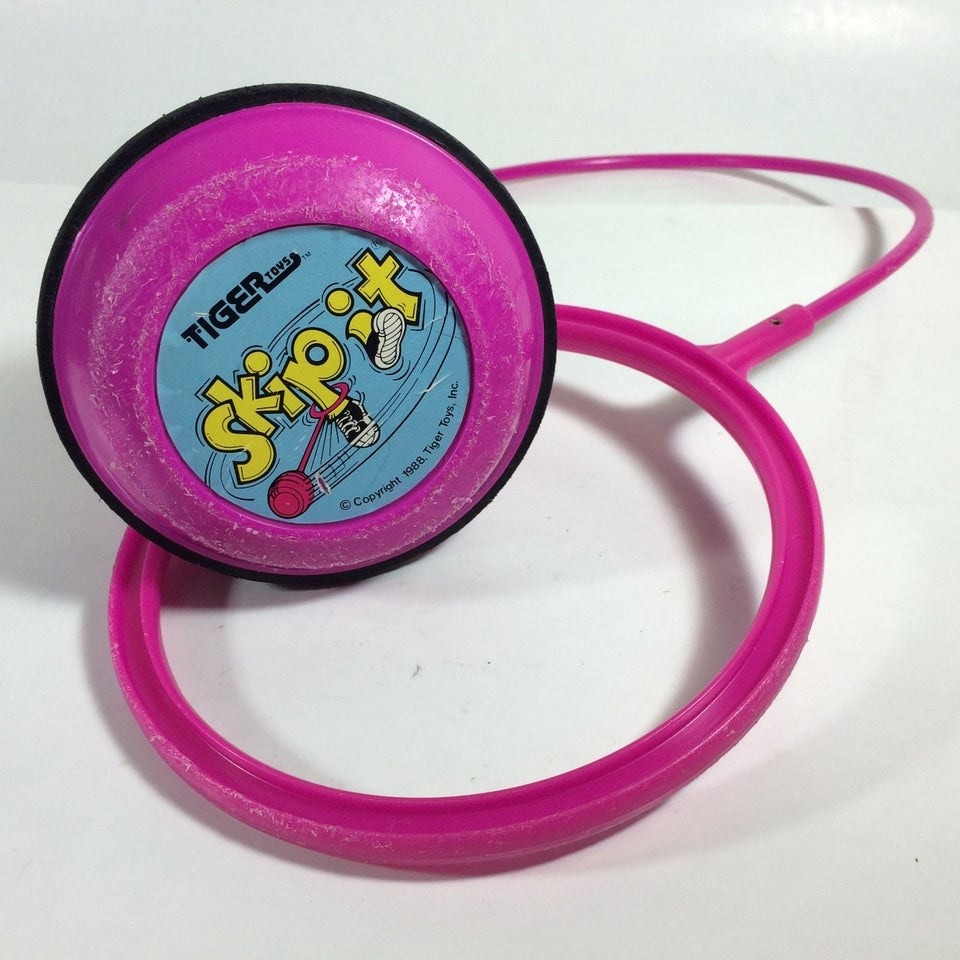 A photo of a purple Skip-It toy.