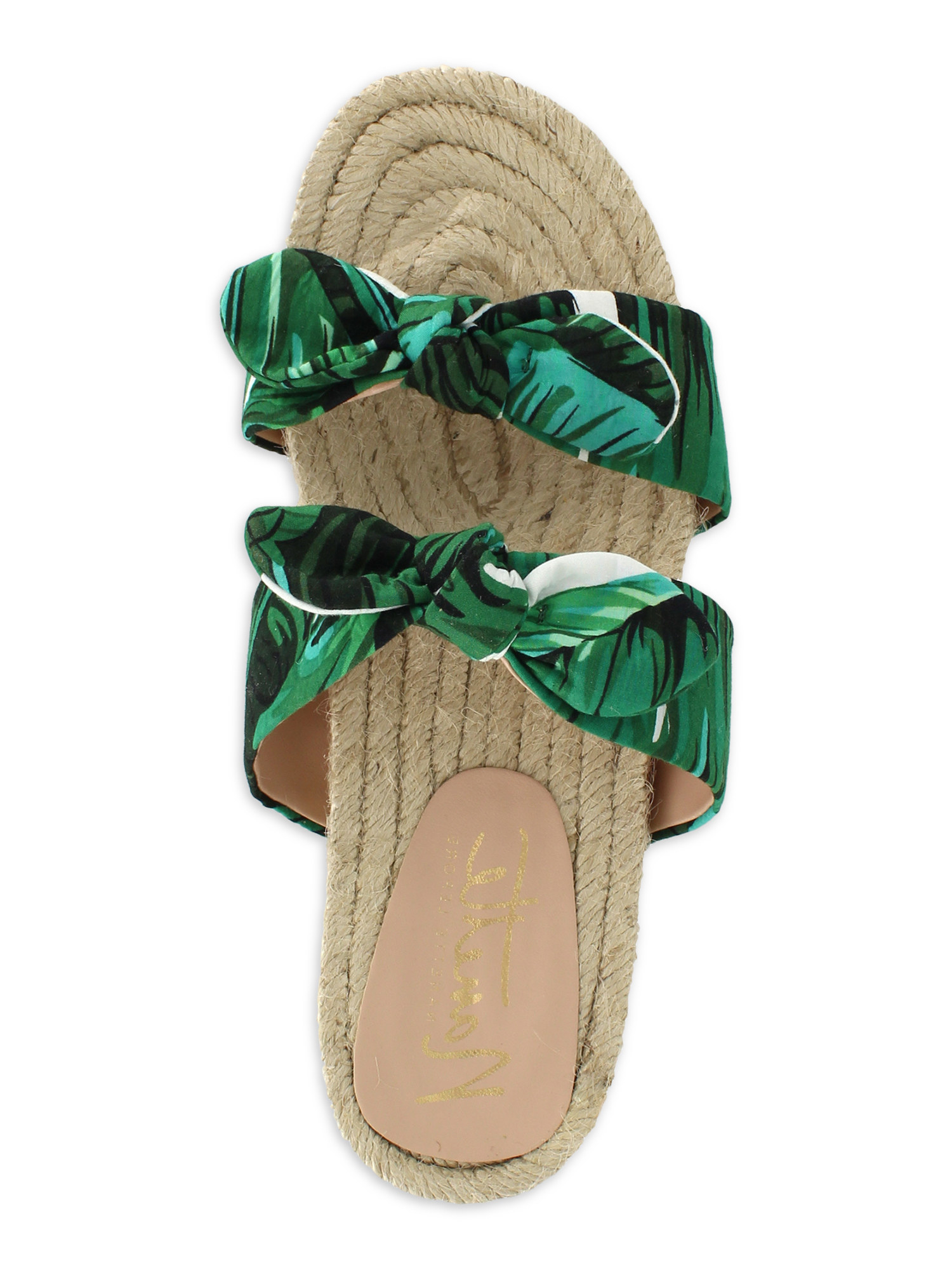 A sandal with a green palm print and a flat woven espadrille sole