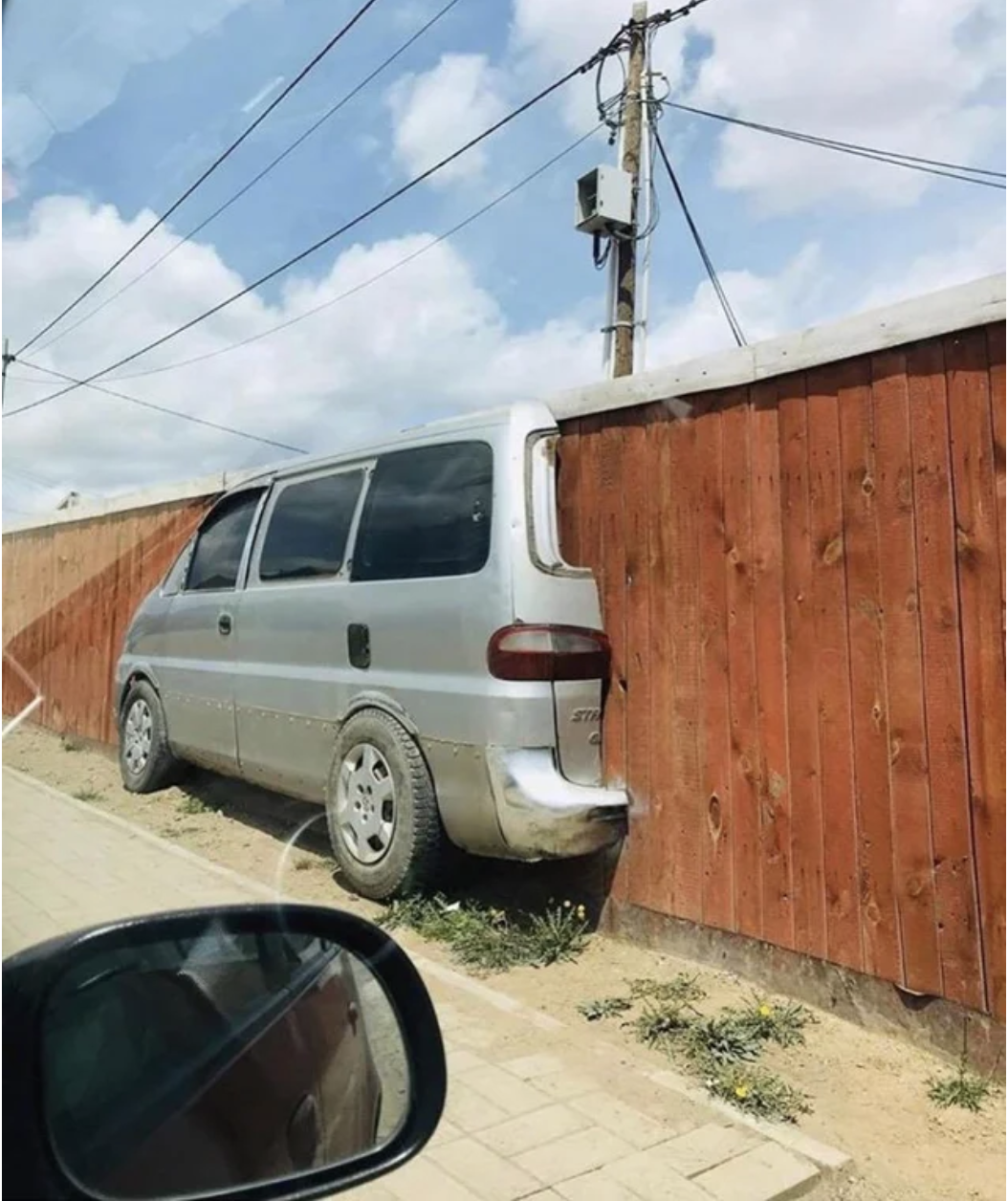 A fence with a truck in the middle of it