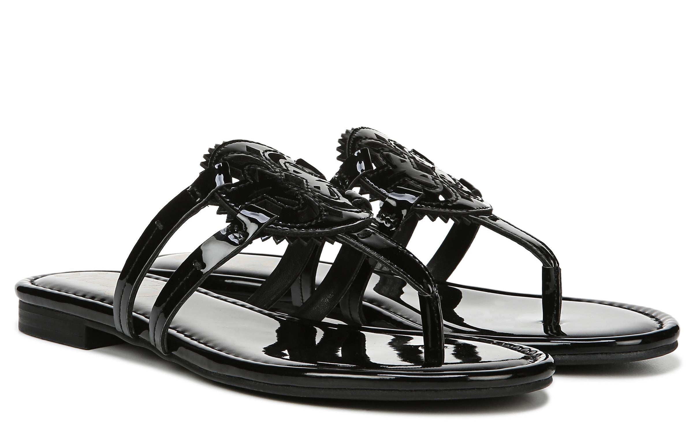 A pair of shiny black sandals