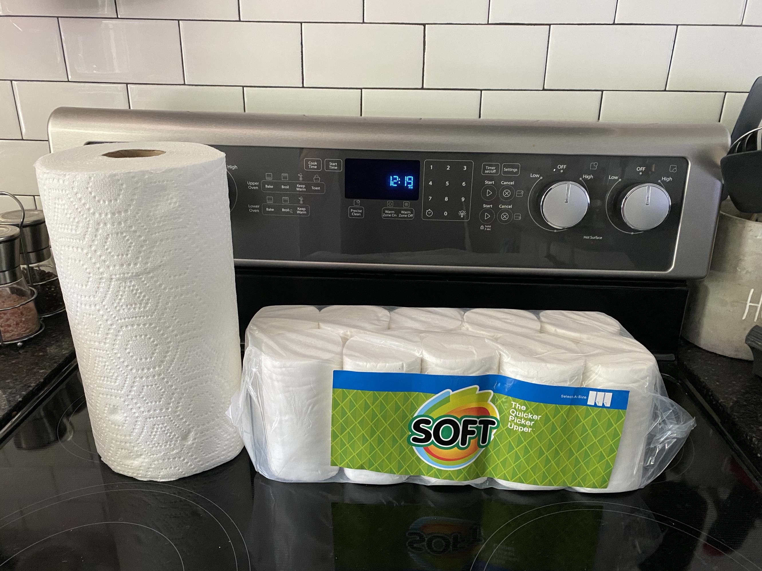 A normal sized roll of paper towels posed next to 10 ridiculously small rolls of paper towels.