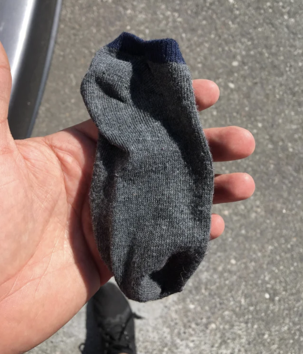 A hand holding a small sock