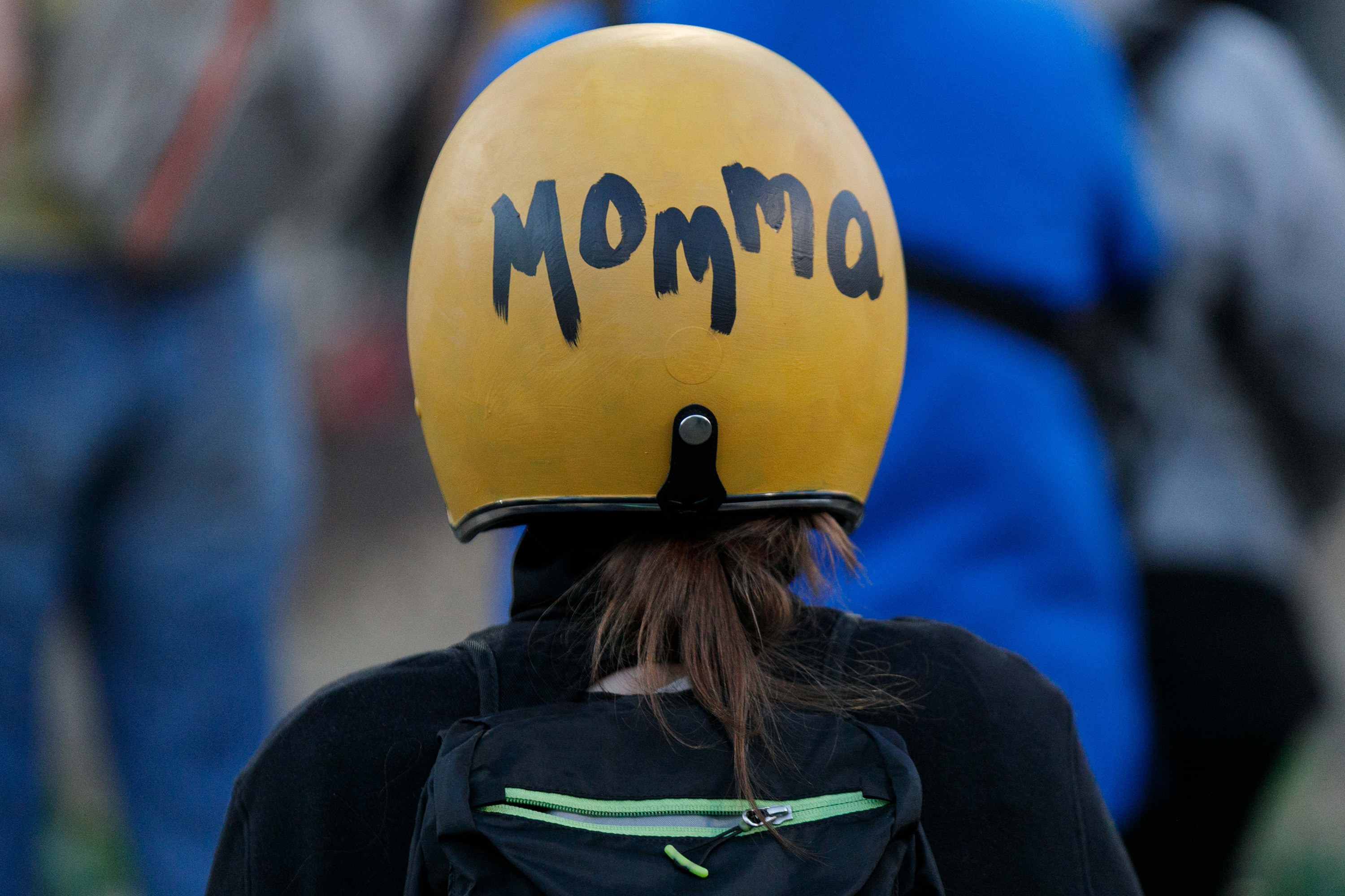 A woman wearing a helmet that says &quot;Momma&quot; at the demonstrations in Portland