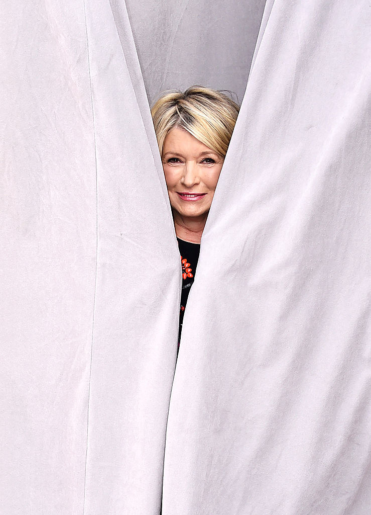 Martha Stewart poking her head out from behind a curtain