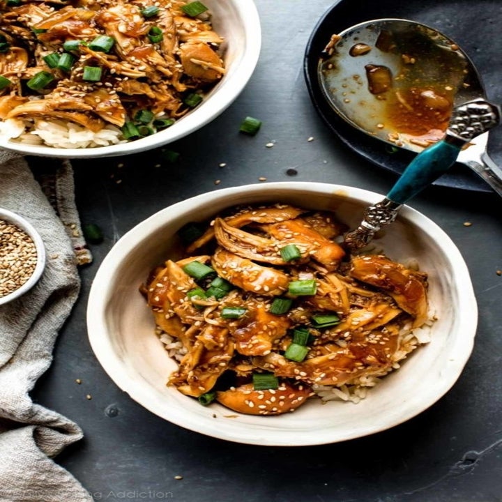 Two bowls of honey teriyaki chicken over rice, ready to be eaten.
