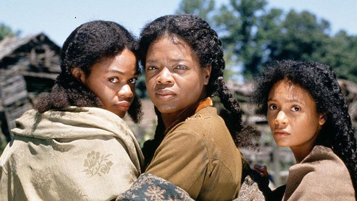 Oprah Winfrey poses with Thandie Newton and Kimberly Elise on the set of Beloved, the 1998 film