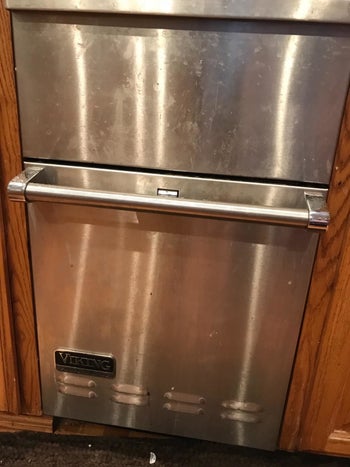 A reviewer showing their dishwasher with prints and stains