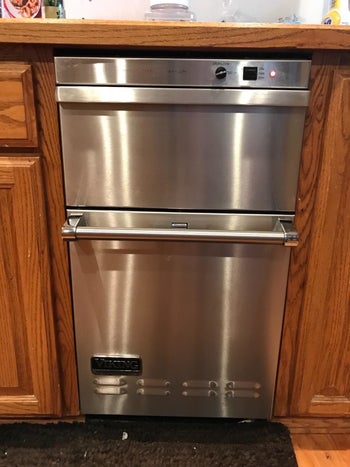 The reviewer's dishwasher looking shiny and stain-free after using the product