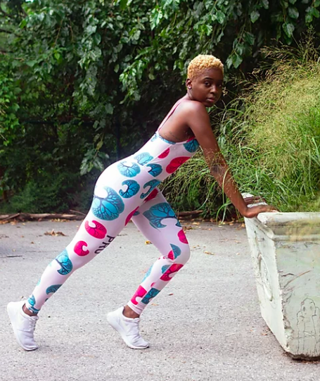 Model wears white, blue, and pink print sleeves bodysuit with sneakers