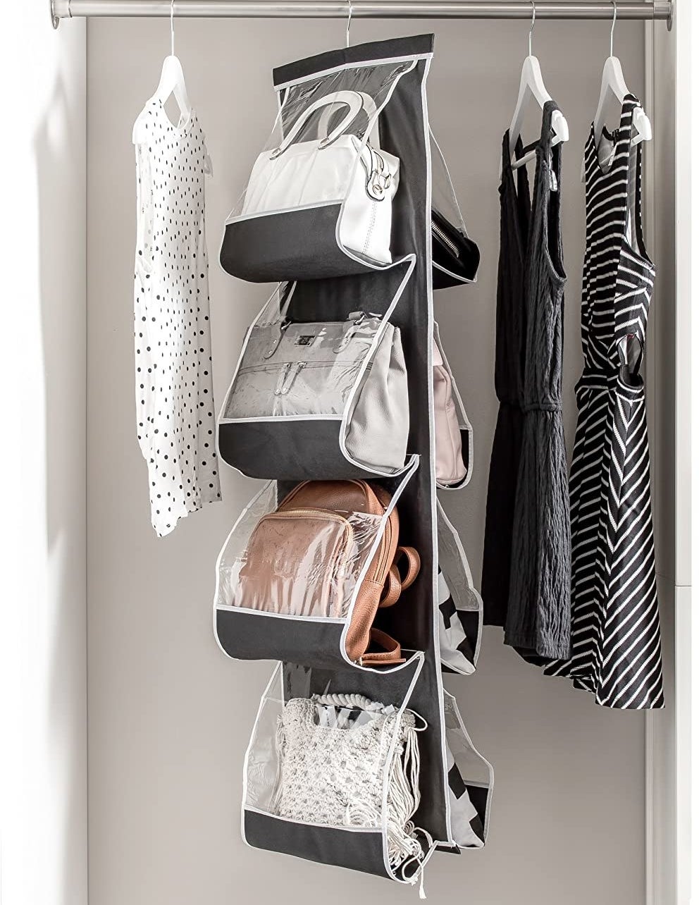 The handbag holder in a closet with eight bags inside