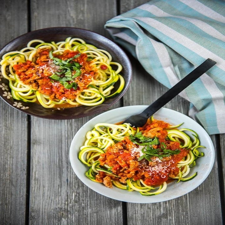 Two bowls of zucchini noodles with turkey Bolognese on top.