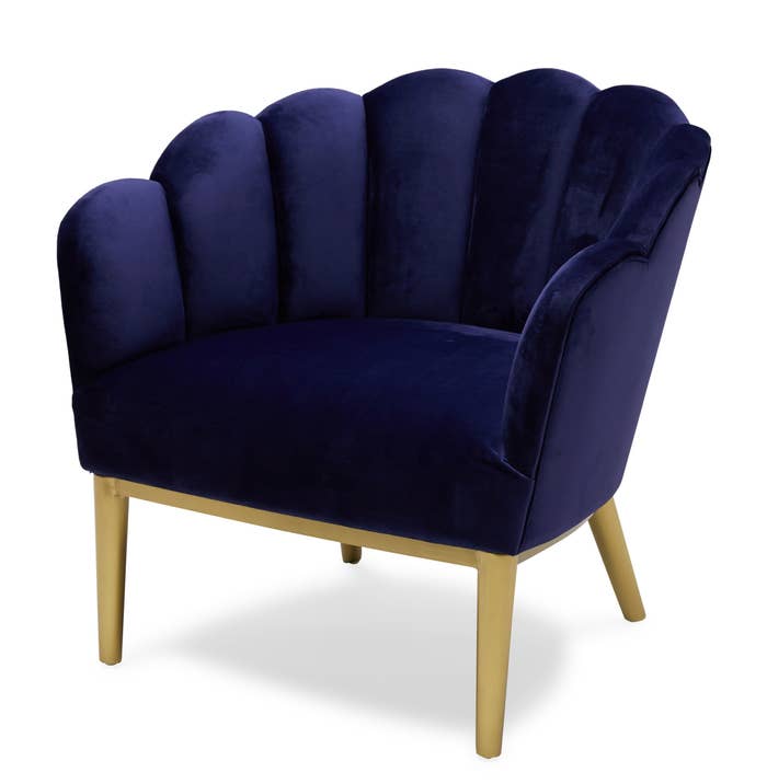 A royal blue chair with gold legs 