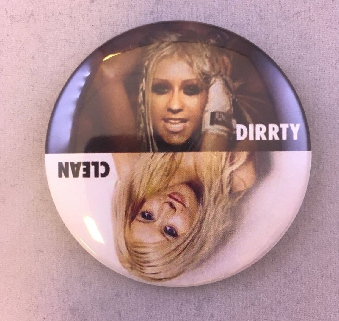 A round magnet with Christina Aguilera from the Dirrty music video on the top and from her Genie In The Bottle days on the bottom