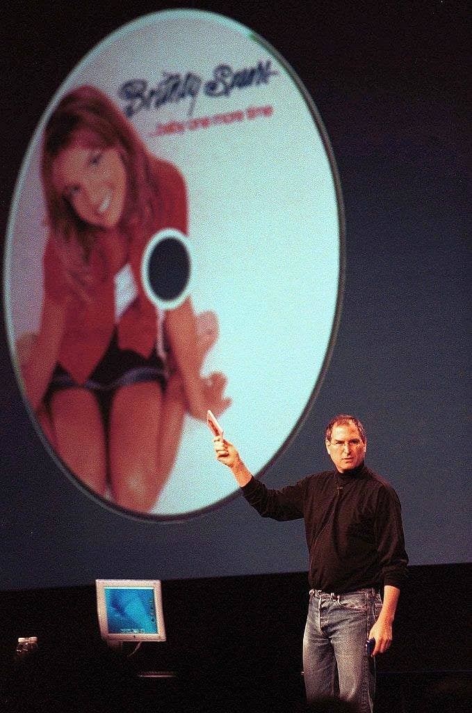 Steve Jobs holding up Britney Spears album Baby One More Time