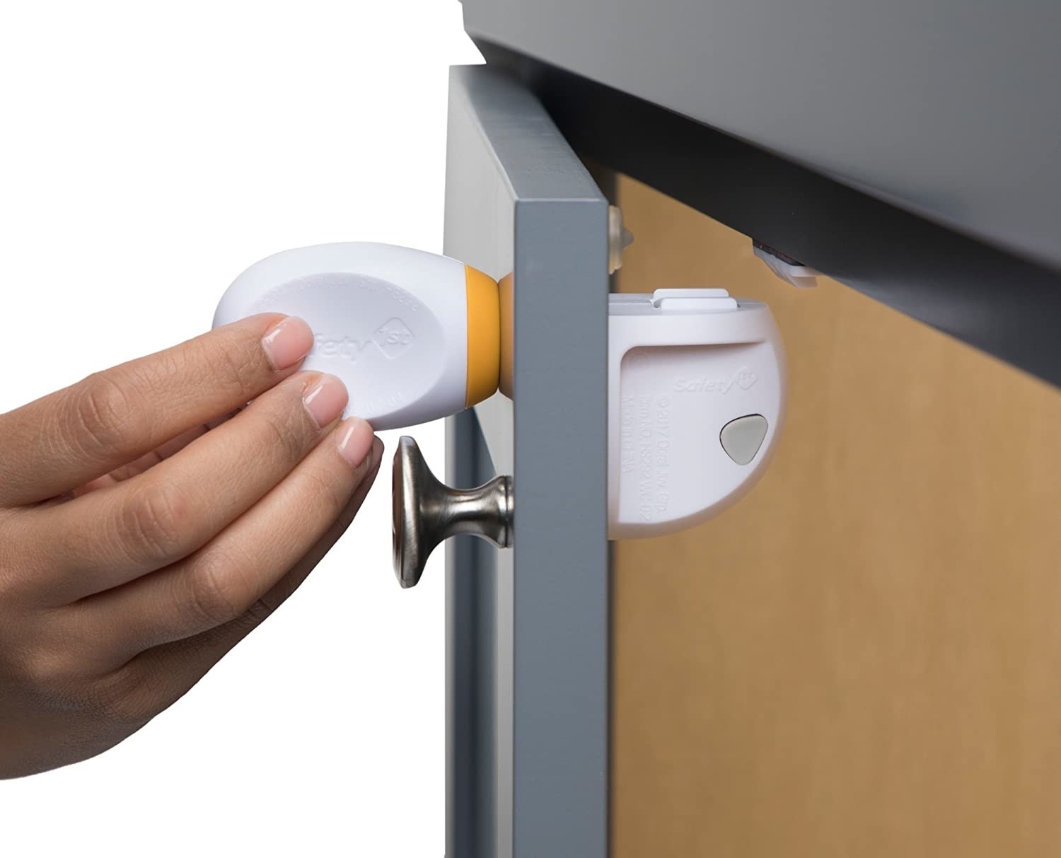 A person holding the unlocking mechanism by an open drawer, showing the lock on the other side 