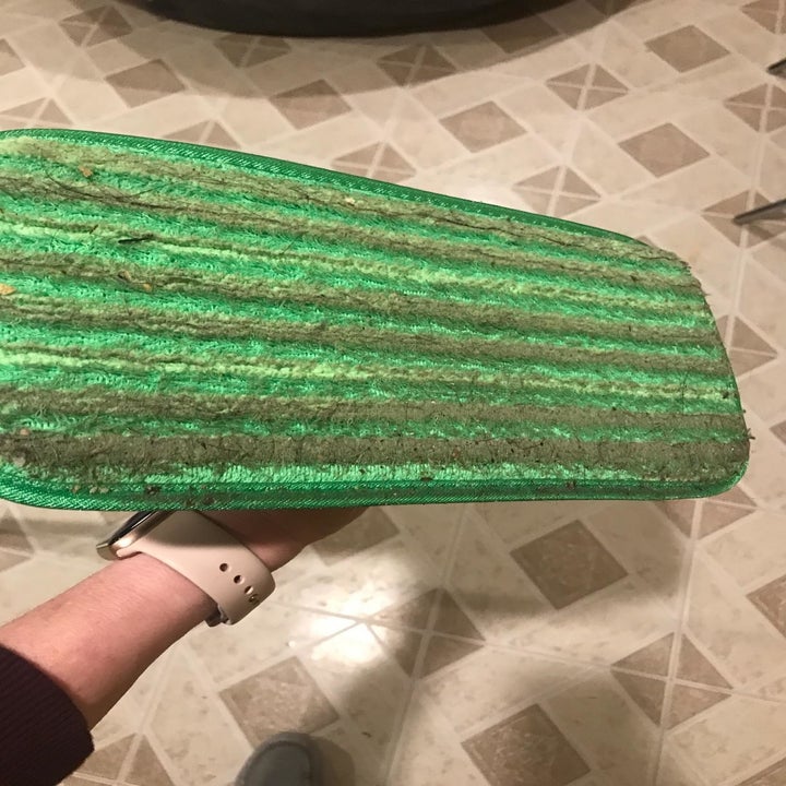 Reviewer showing the bottom of the bad full of dirt and dust after cleaning 