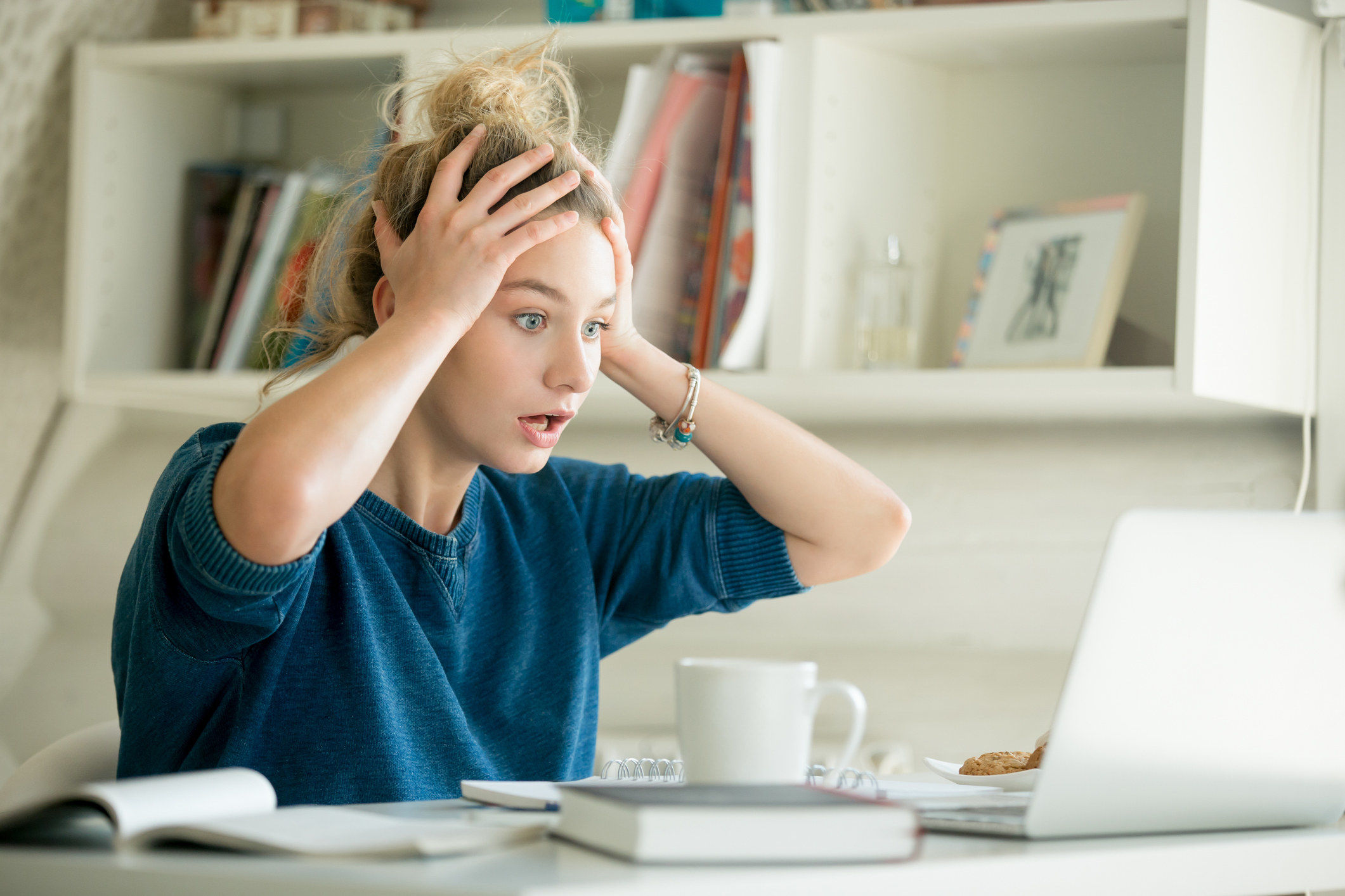 Stock photo of girl making a shocked face at laptop