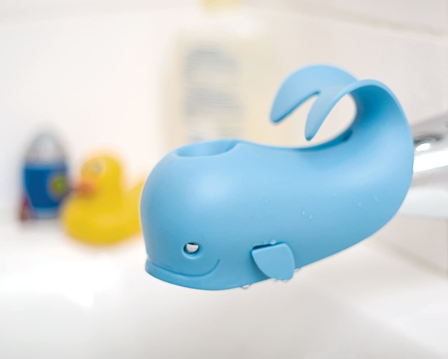 A whale shaped bath cover with a spout hole for the plug attachment