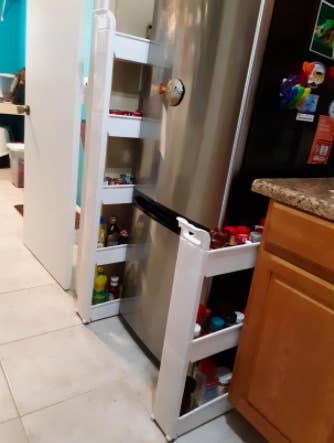 reviewer pic of the rolling cart between the fridge and kitchen cabinet