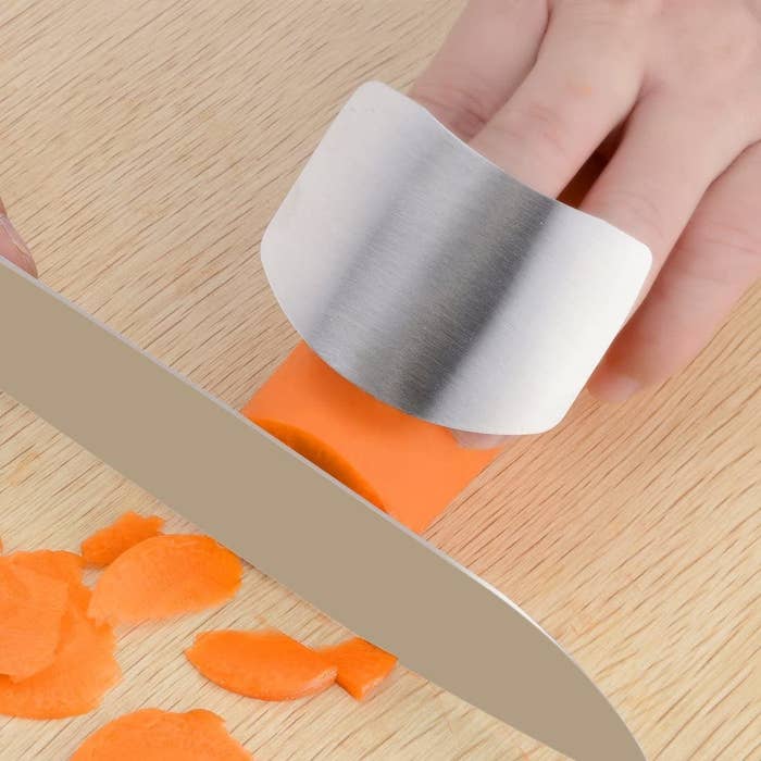 The guard on a finger chopping carrots