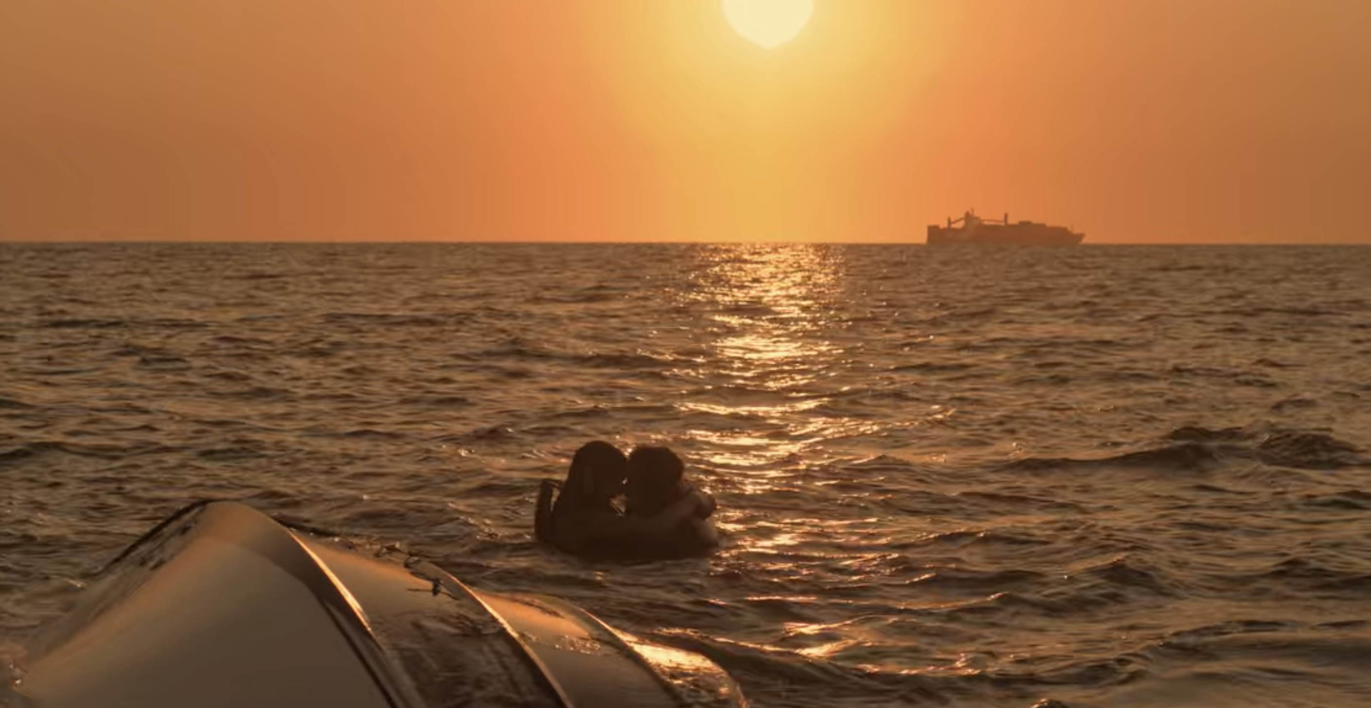 Sarah and John B. hugging in the ocean right before getting rescued