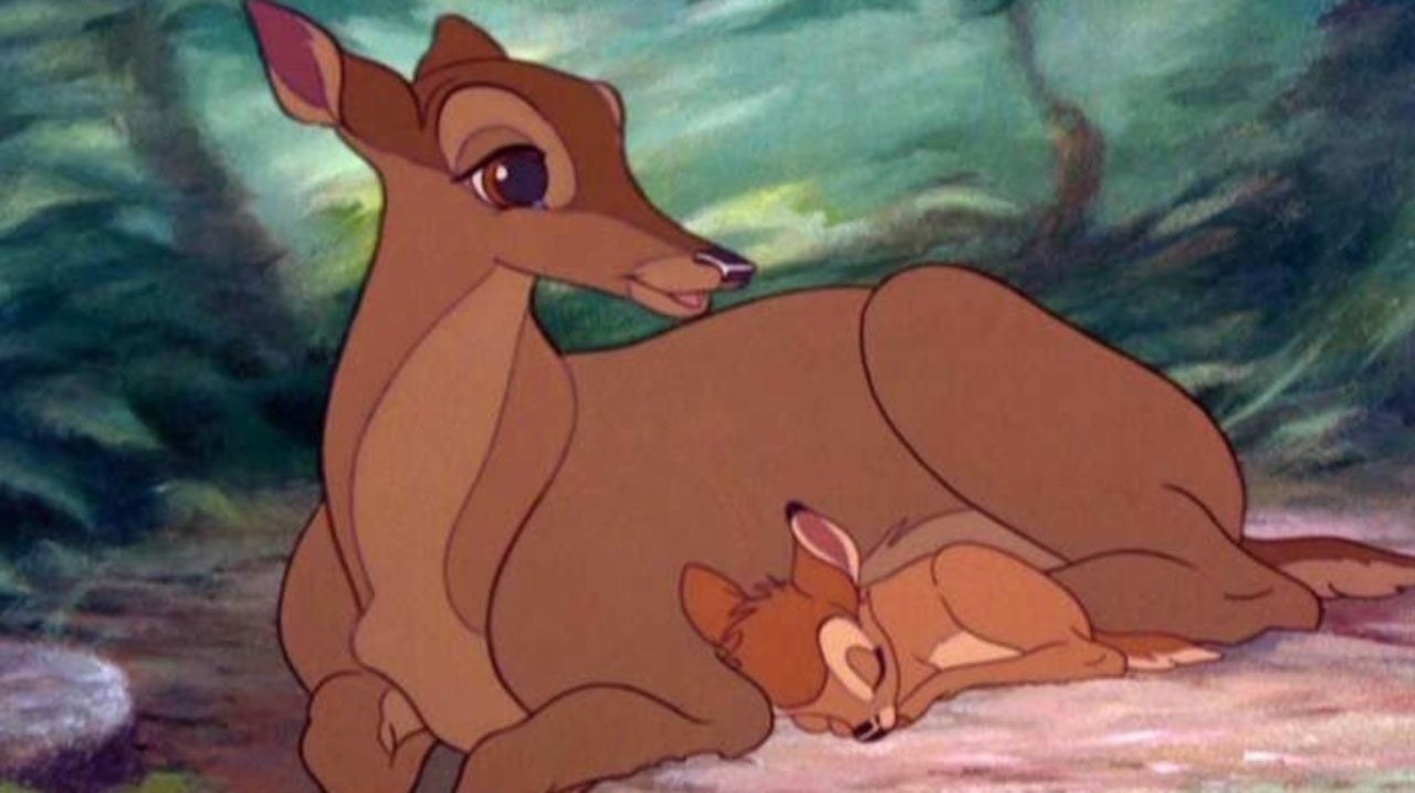 Bambi cuddles with his mother in a forrest