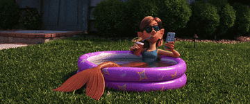 Mermaid from &quot;Onward&quot; sips a drink and checks their phone in a blow-up pool