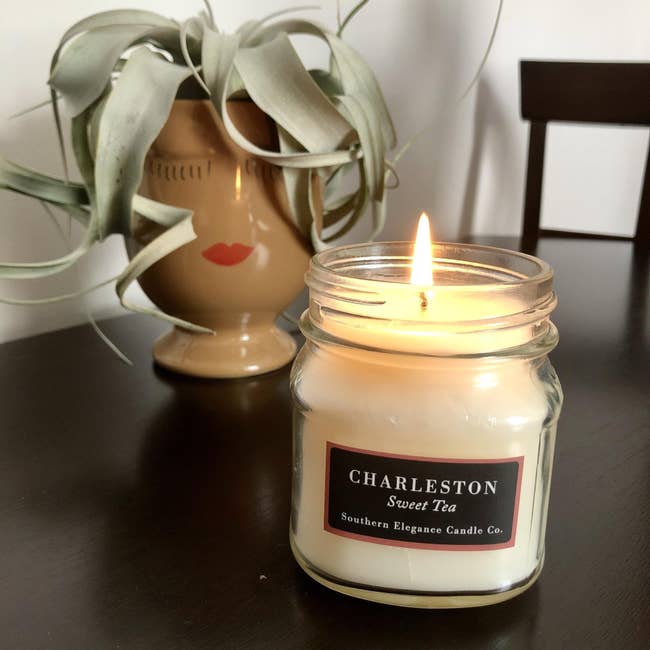 BuzzFeed Shopping editor's picture of the candle on a table 