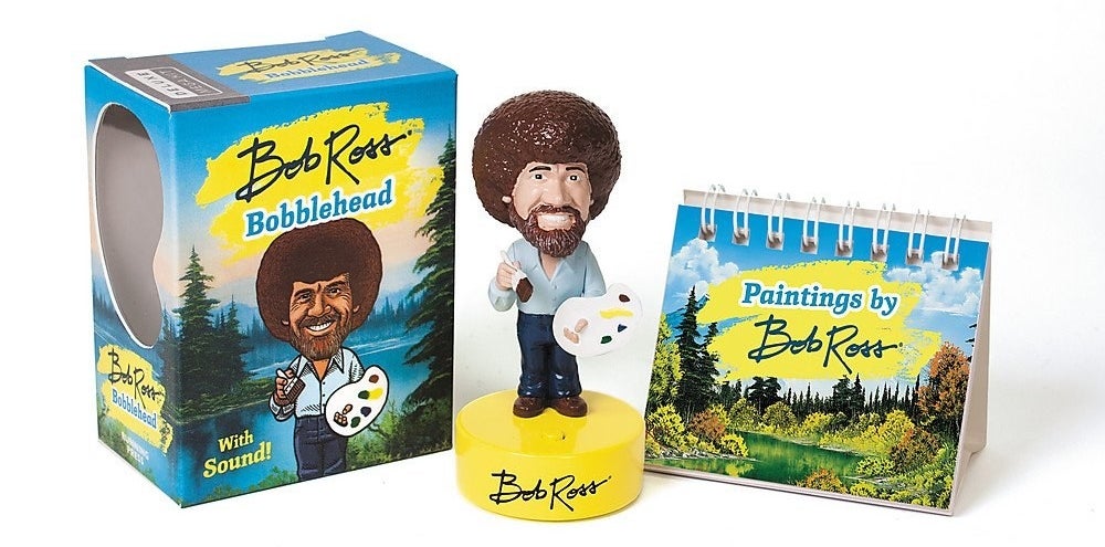 A Bob Ross figurine next to its package