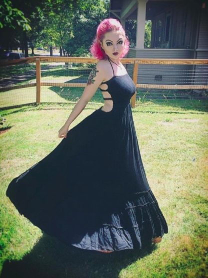 reviewer wearing the black full skirt maxi spinning to show how full the skirt it