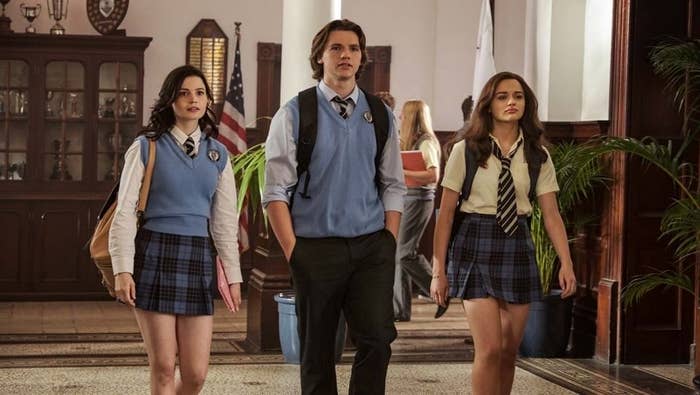 Rachel, Lee, and Elle walking down the hallway of their school in "The Kissing Booth 2."