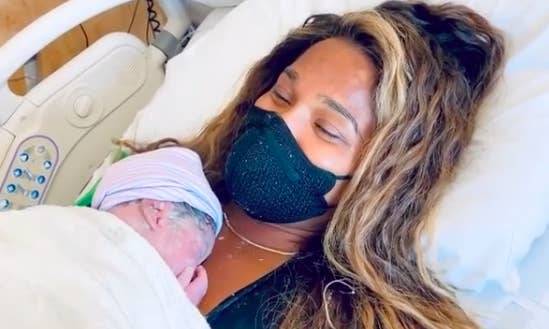 Ciara holding her newborn son in the hospital.