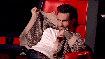 Adam hides his face behind his cardigan on &quot;The Voice&quot;